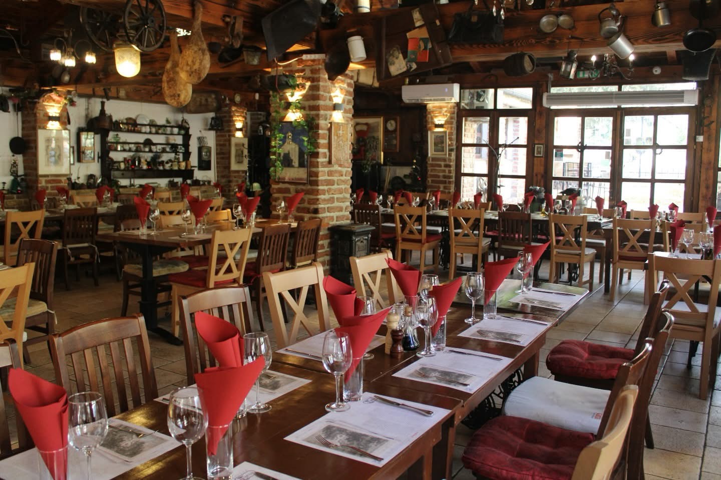 Rustic dining room with tables set under a ceiling of vintage items