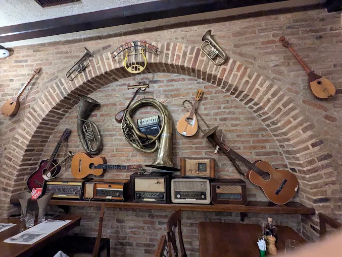 Brick arch hung with old instruments and vintage radios